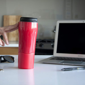 Person-holding-reusable-bottle-at-their-desk