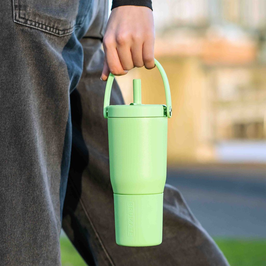 Brumate-Resa-35oz-Woman-Walking-with-Bottle-scaled